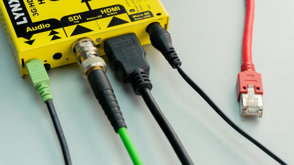 Cabo HDMI conectado em um dispositivo com outros tipos de cabos e outros tipos de entrada também, como de áudio, SDI e micro SD